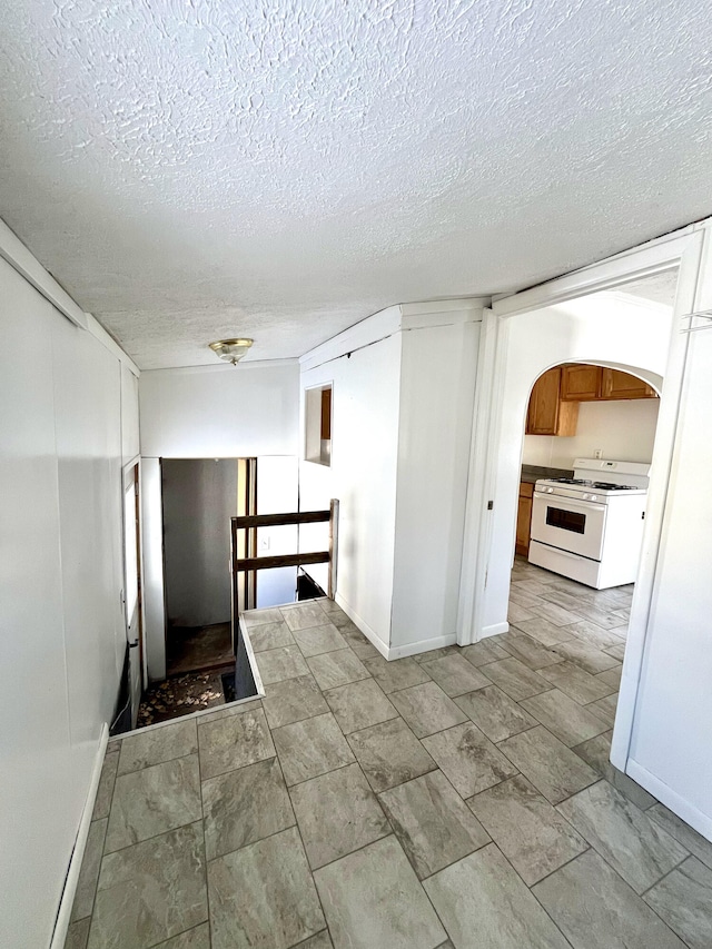 hallway with a textured ceiling