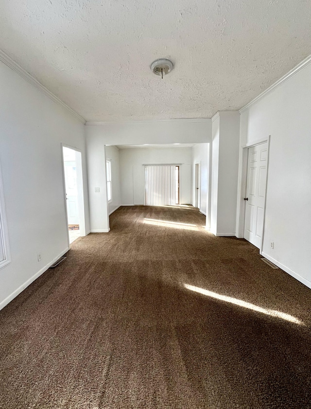 carpeted spare room featuring a textured ceiling and ornamental molding