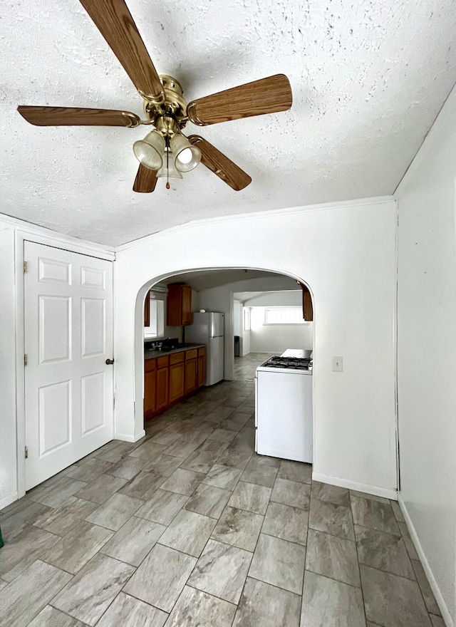 interior space featuring ceiling fan and a textured ceiling