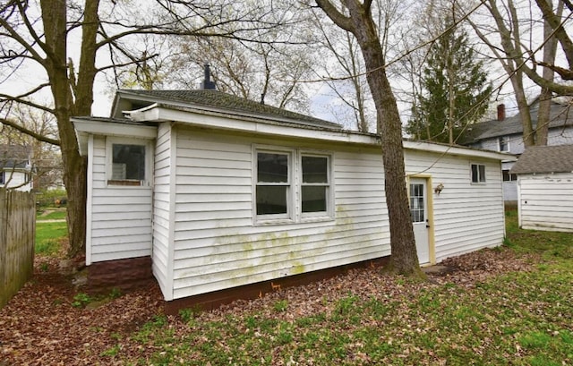 view of side of home featuring an outbuilding