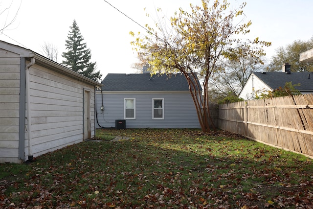 back of house featuring cooling unit and a yard