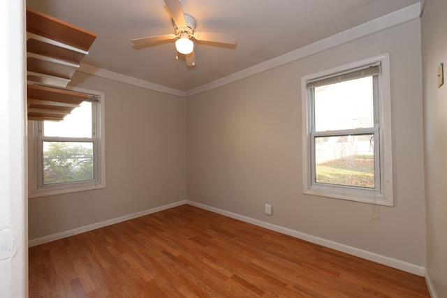 unfurnished room featuring ceiling fan, plenty of natural light, light hardwood / wood-style flooring, and ornamental molding