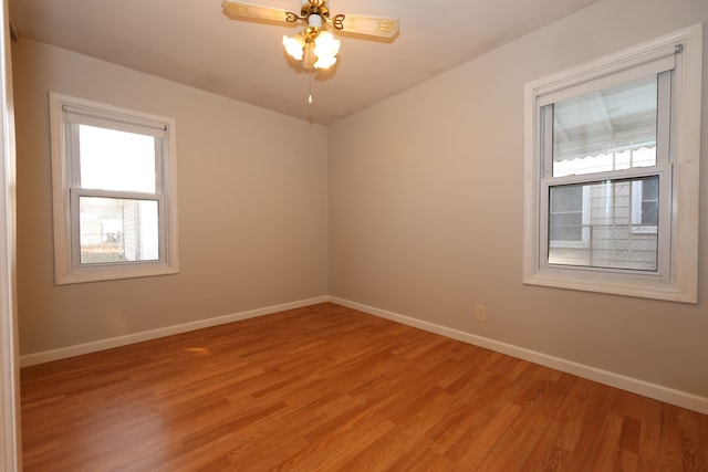 unfurnished room with light wood-type flooring and ceiling fan