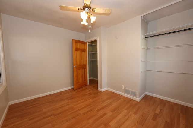 unfurnished bedroom with ceiling fan, light hardwood / wood-style floors, and a closet