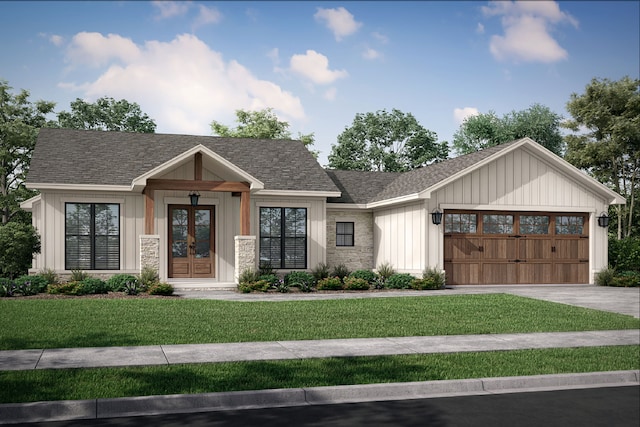 view of front of house with french doors, a front yard, and a garage