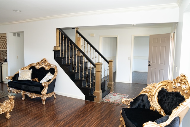 living room featuring dark hardwood / wood-style flooring and ornamental molding