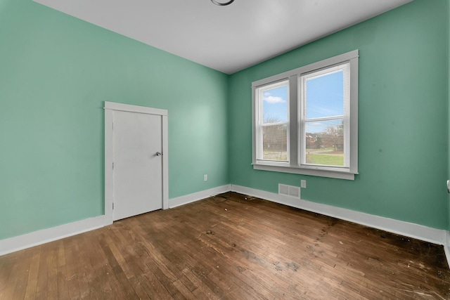 spare room with wood-type flooring