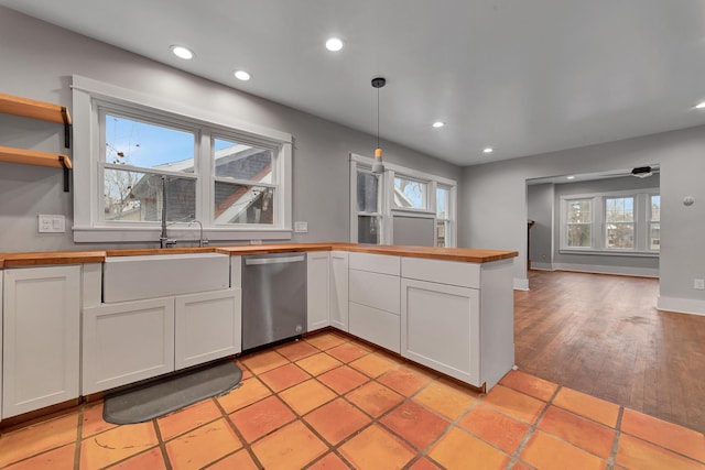 kitchen with white cabinets, pendant lighting, stainless steel dishwasher, and plenty of natural light