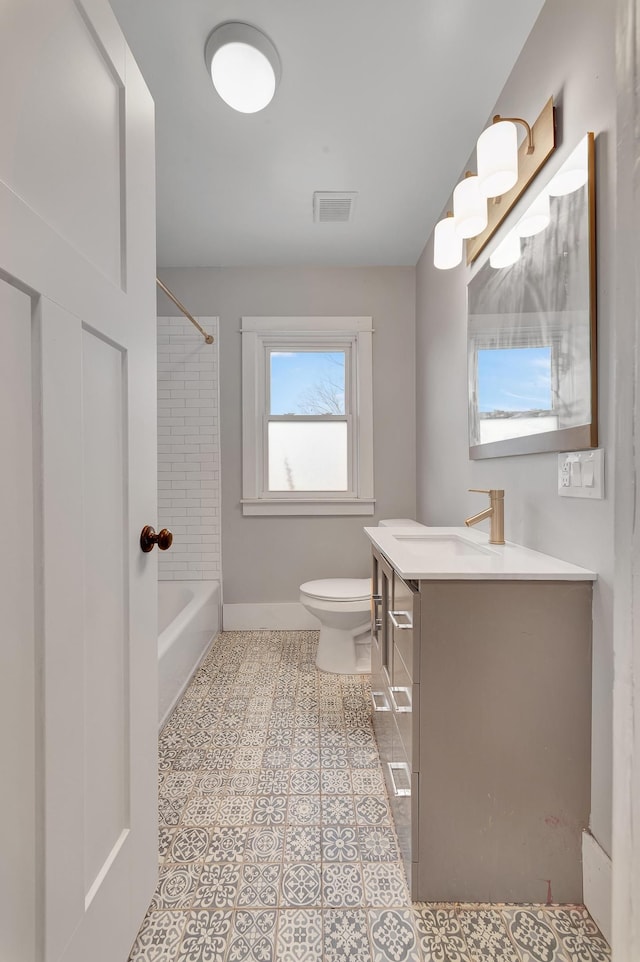 full bathroom featuring tile patterned floors, vanity, toilet, and tiled shower / bath