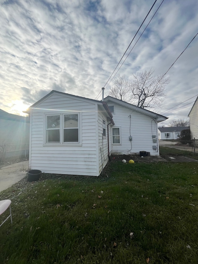 view of side of property with a lawn