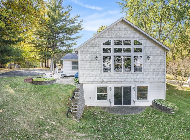 rear view of property featuring a patio area and a yard