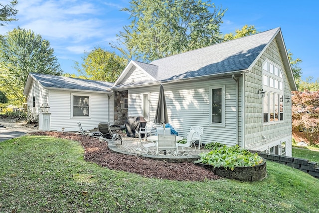 view of front facade with a patio and a front yard