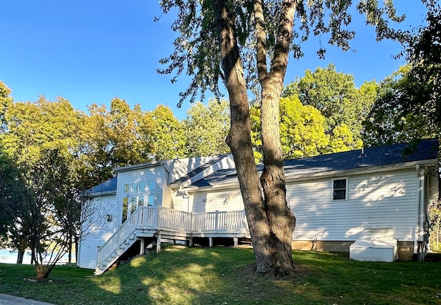 rear view of house with a lawn and a deck