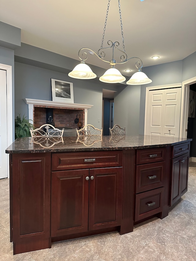 bar featuring hanging light fixtures and dark stone counters