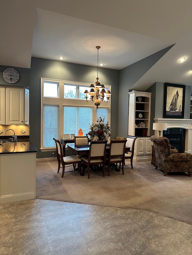 carpeted dining space with an inviting chandelier and sink