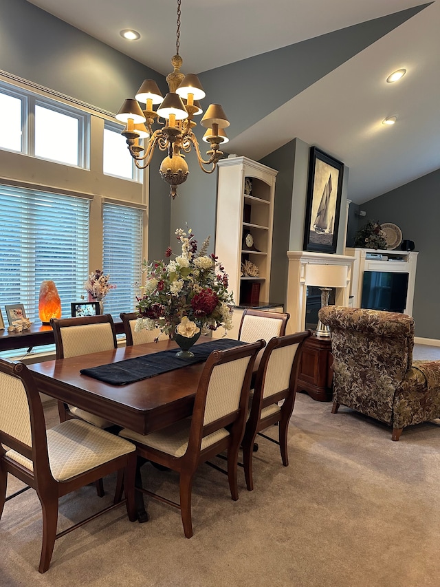 dining space with light carpet, a chandelier, and vaulted ceiling