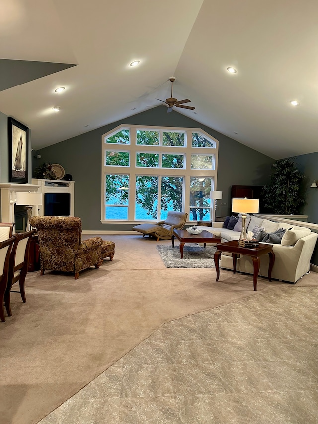 carpeted living room with ceiling fan and lofted ceiling