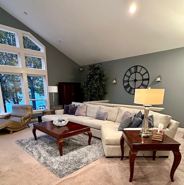 carpeted living room with high vaulted ceiling