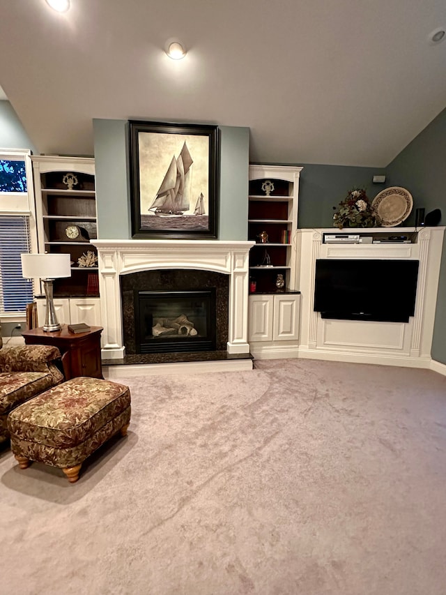 living room with carpet, vaulted ceiling, and a premium fireplace