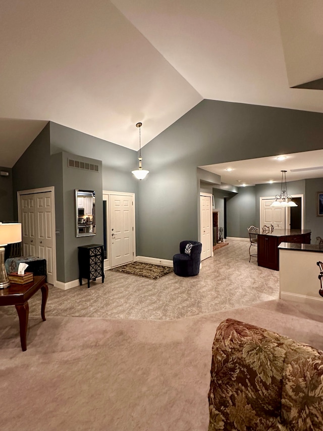 living room with light carpet and vaulted ceiling