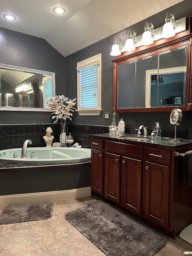 bathroom featuring tile patterned floors, vanity, and vaulted ceiling