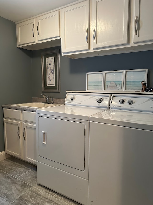 washroom featuring washer and clothes dryer, cabinets, and sink