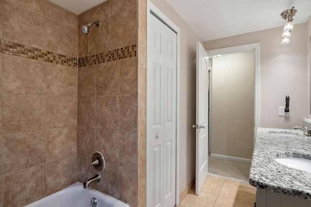 bathroom featuring tile patterned flooring, vanity, and tiled shower / bath combo