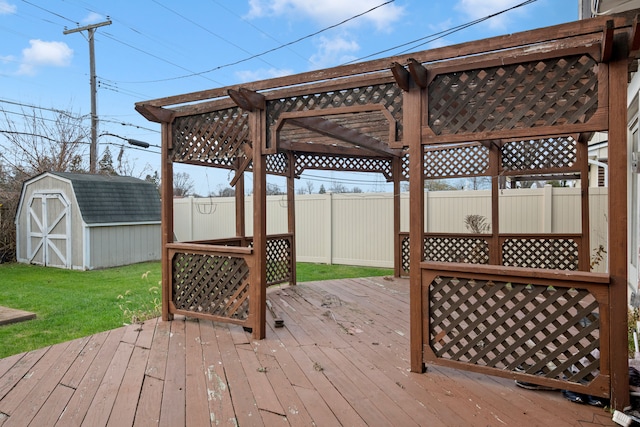 wooden terrace featuring a storage unit, a yard, and a pergola