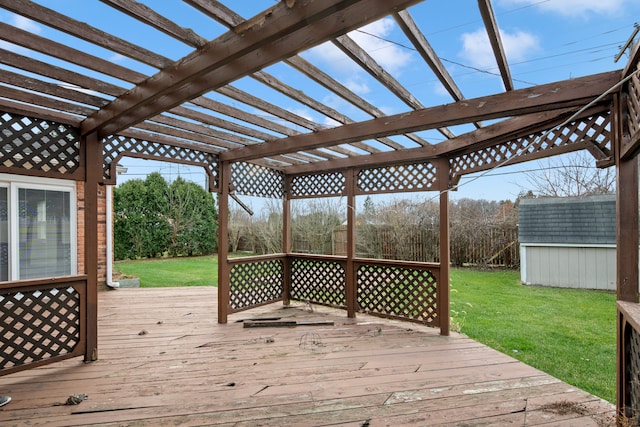 deck featuring a storage shed, a pergola, and a yard