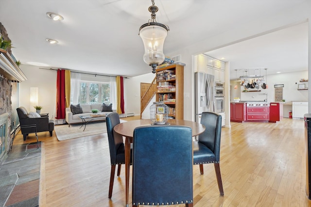 dining area with light hardwood / wood-style floors