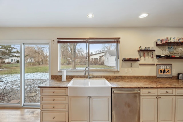 kitchen with light hardwood / wood-style floors, sink, and cream cabinets