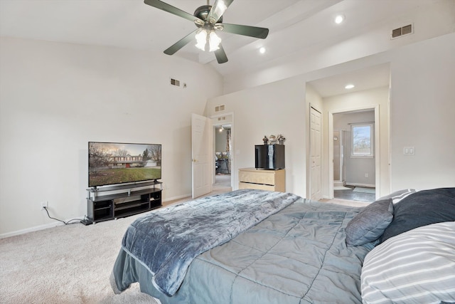 carpeted bedroom with ceiling fan and high vaulted ceiling