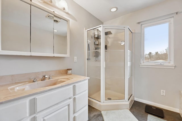 bathroom with vanity and a shower with door