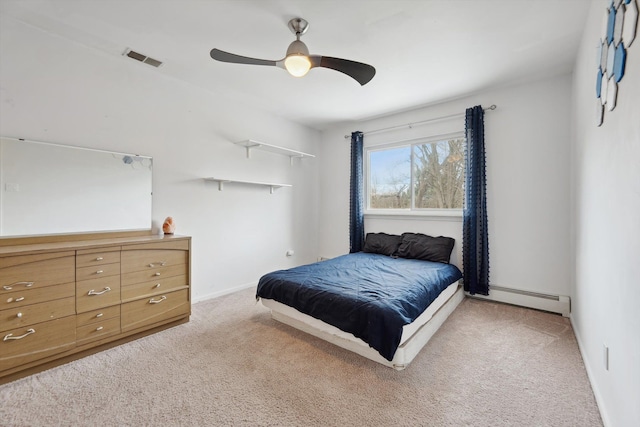 carpeted bedroom with ceiling fan and a baseboard radiator