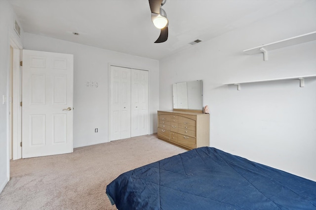 carpeted bedroom with ceiling fan and a closet