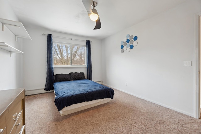 carpeted bedroom with ceiling fan and a baseboard radiator