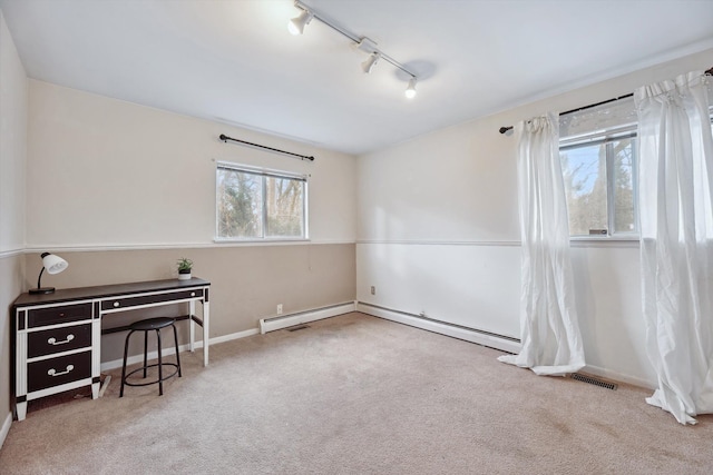 carpeted spare room featuring rail lighting