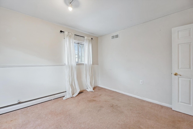 carpeted spare room with a baseboard radiator