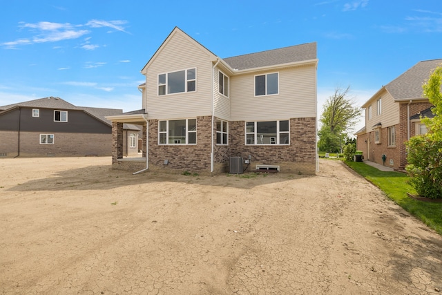 rear view of property featuring central AC