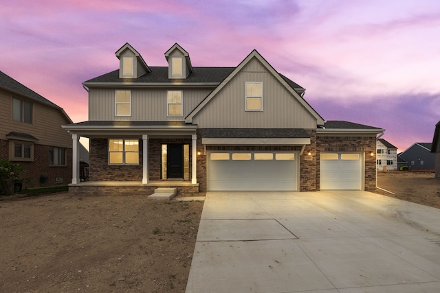 view of front of house featuring a porch and a garage