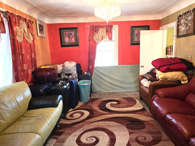 carpeted living room featuring a chandelier