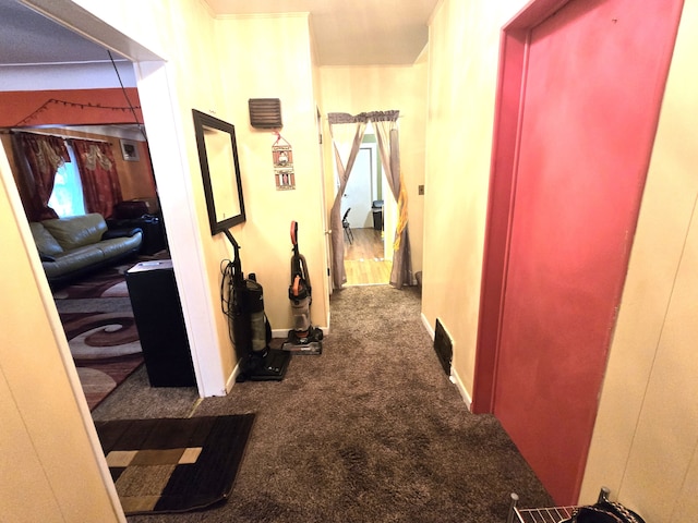 corridor featuring dark colored carpet