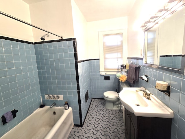 full bathroom with vanity, tiled shower / bath combo, tile walls, and toilet