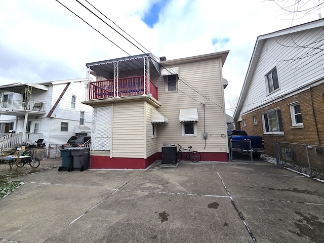 back of property with a balcony and central air condition unit