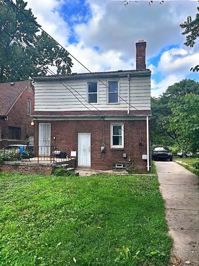 rear view of property with a yard