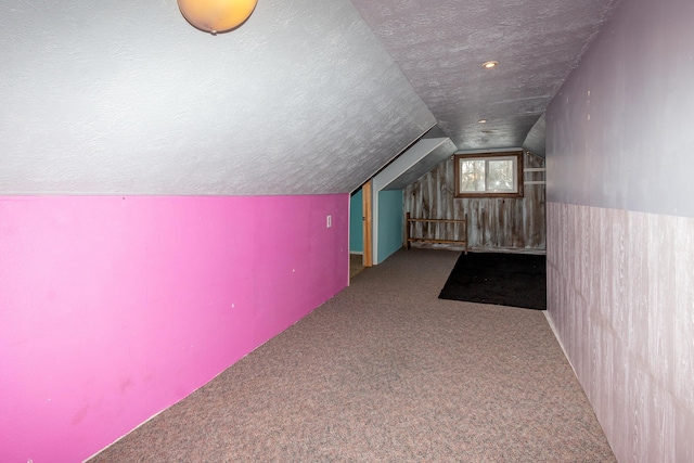 bonus room featuring carpet floors, a textured ceiling, and vaulted ceiling