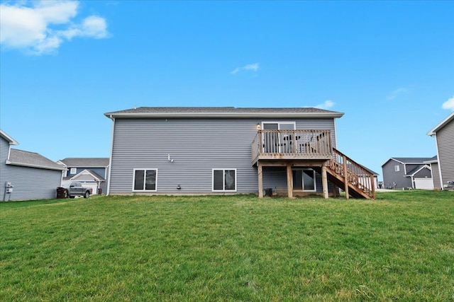 back of house featuring a wooden deck and a lawn