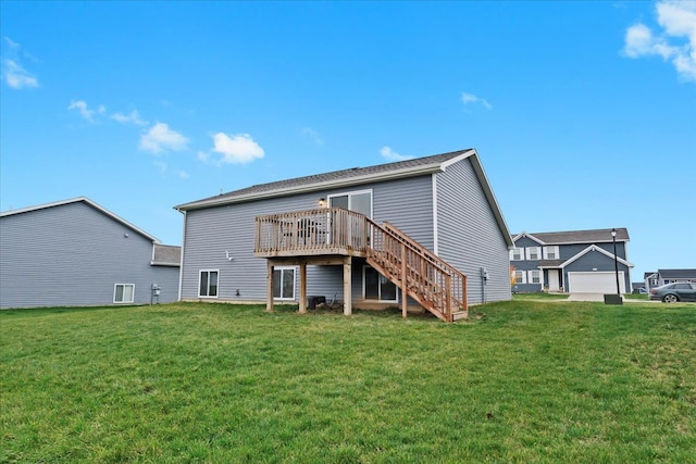 rear view of house featuring a lawn and a deck