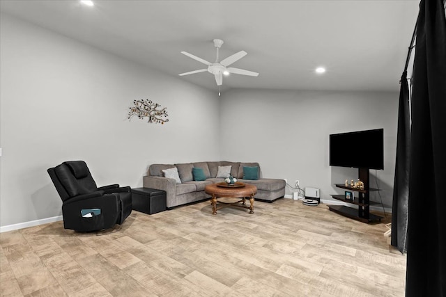 living room featuring ceiling fan, light hardwood / wood-style flooring, and lofted ceiling