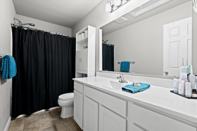 bathroom with hardwood / wood-style floors, vanity, and toilet